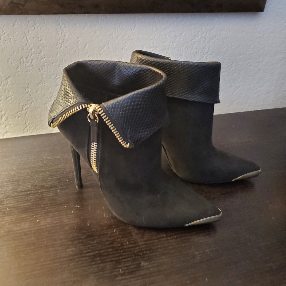 Black booties with gold accents